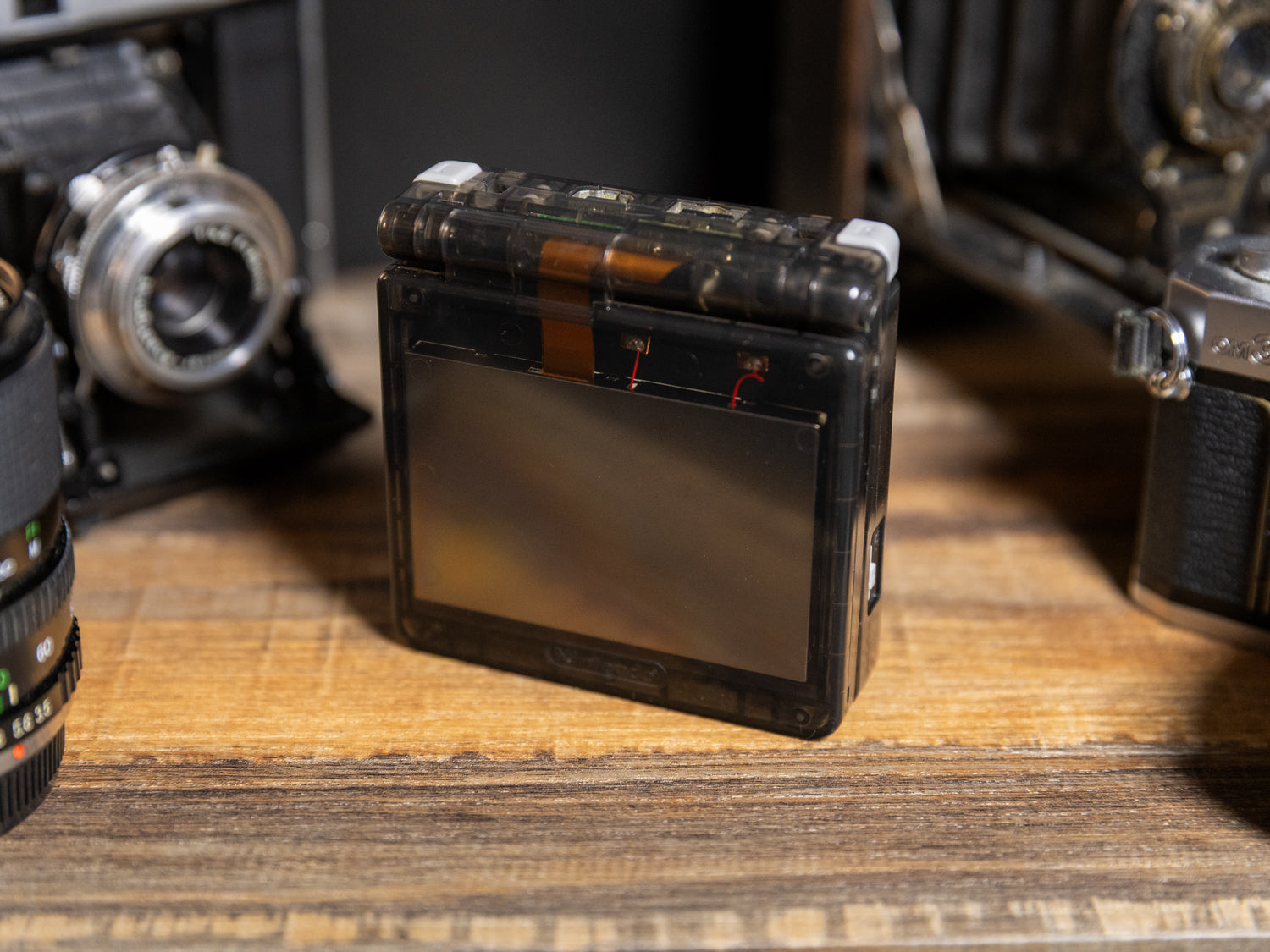 Game Boy Advance SP Clear Smoke Black - Back view transparent shell showcasing Nintendo AGS-101 motherboard