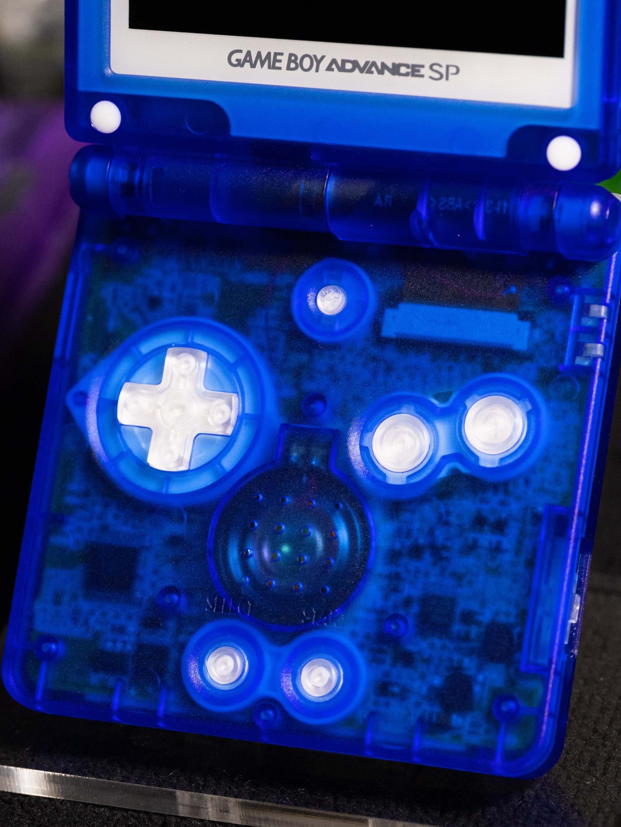 Game Boy Advance SP Blastoise Evolution Edition with transparent blue shell and Pokémon artwork on lid