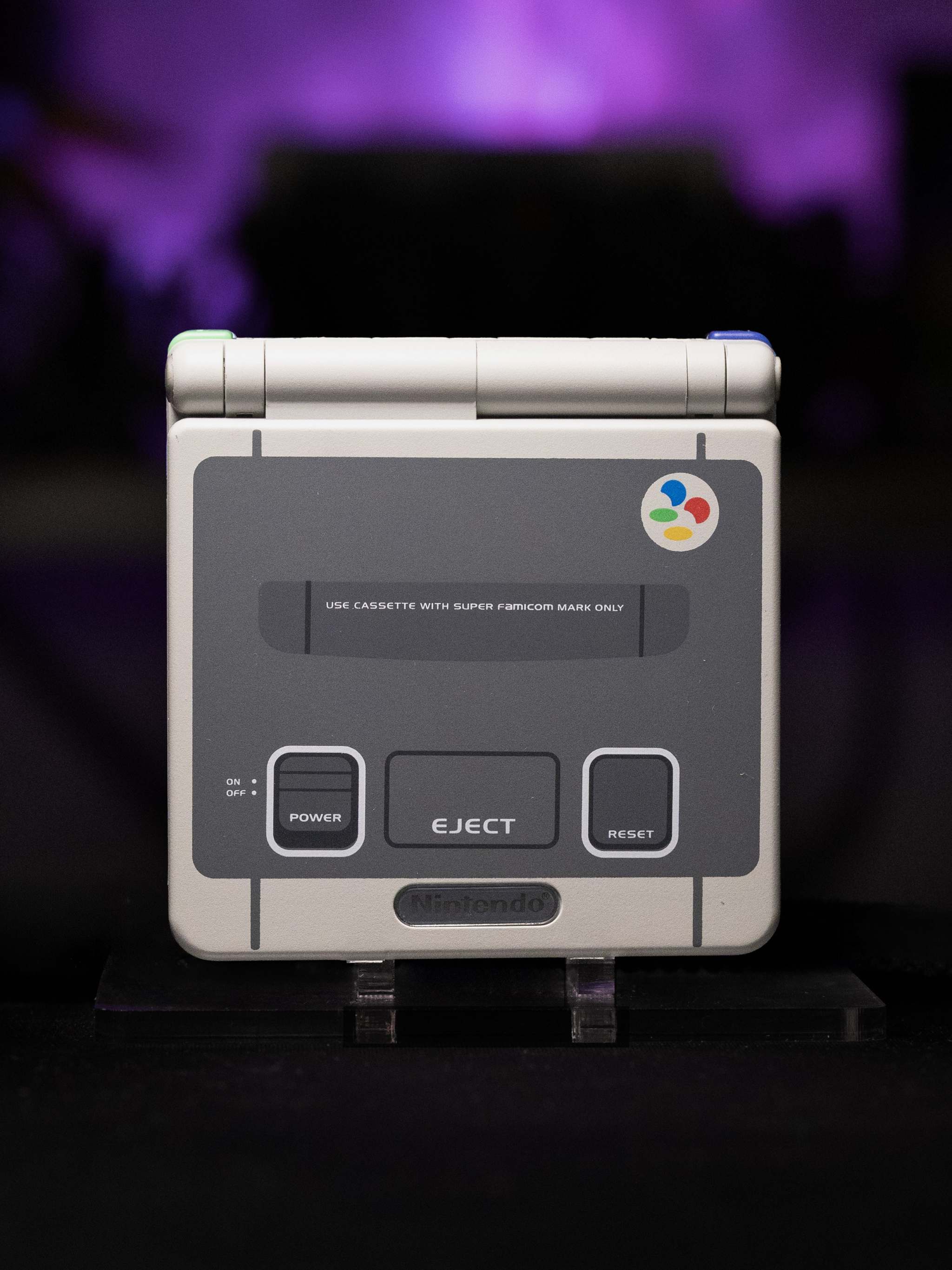Gameboy Advance SP Super Famicom Edition with grey shell and colored buttons, modern IPS V5 display, rechargeable battery, and retro design