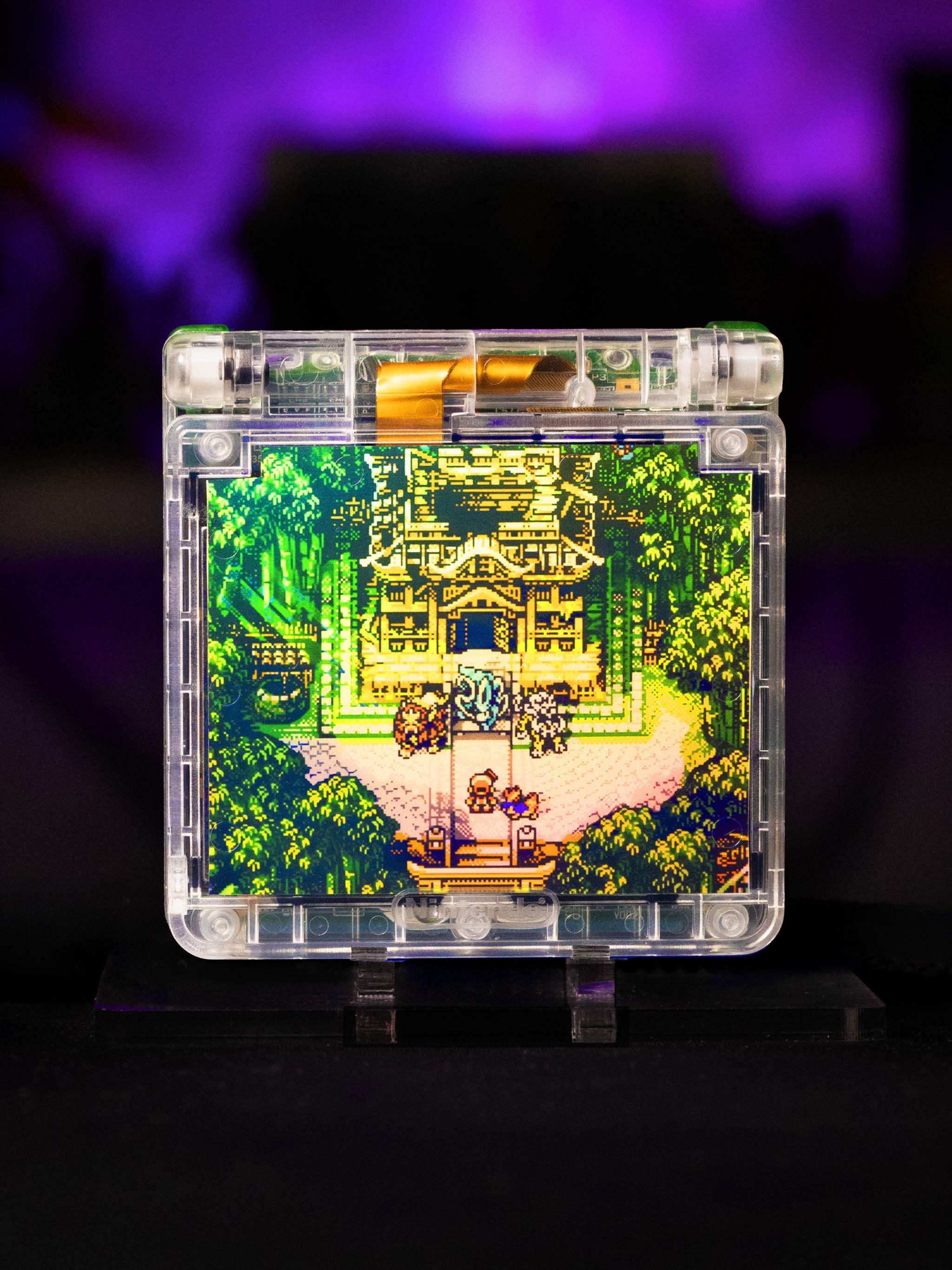 Game Boy Advance SP Legendary Beasts Edition with Johto-inspired artwork and IPS V5 backlit display in transparent shell