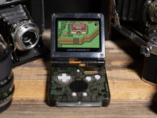 Game Boy Advance SP Transparent Black - Open console showing IPS V5 screen with Zelda visible Nintendo circuitry smoke shell