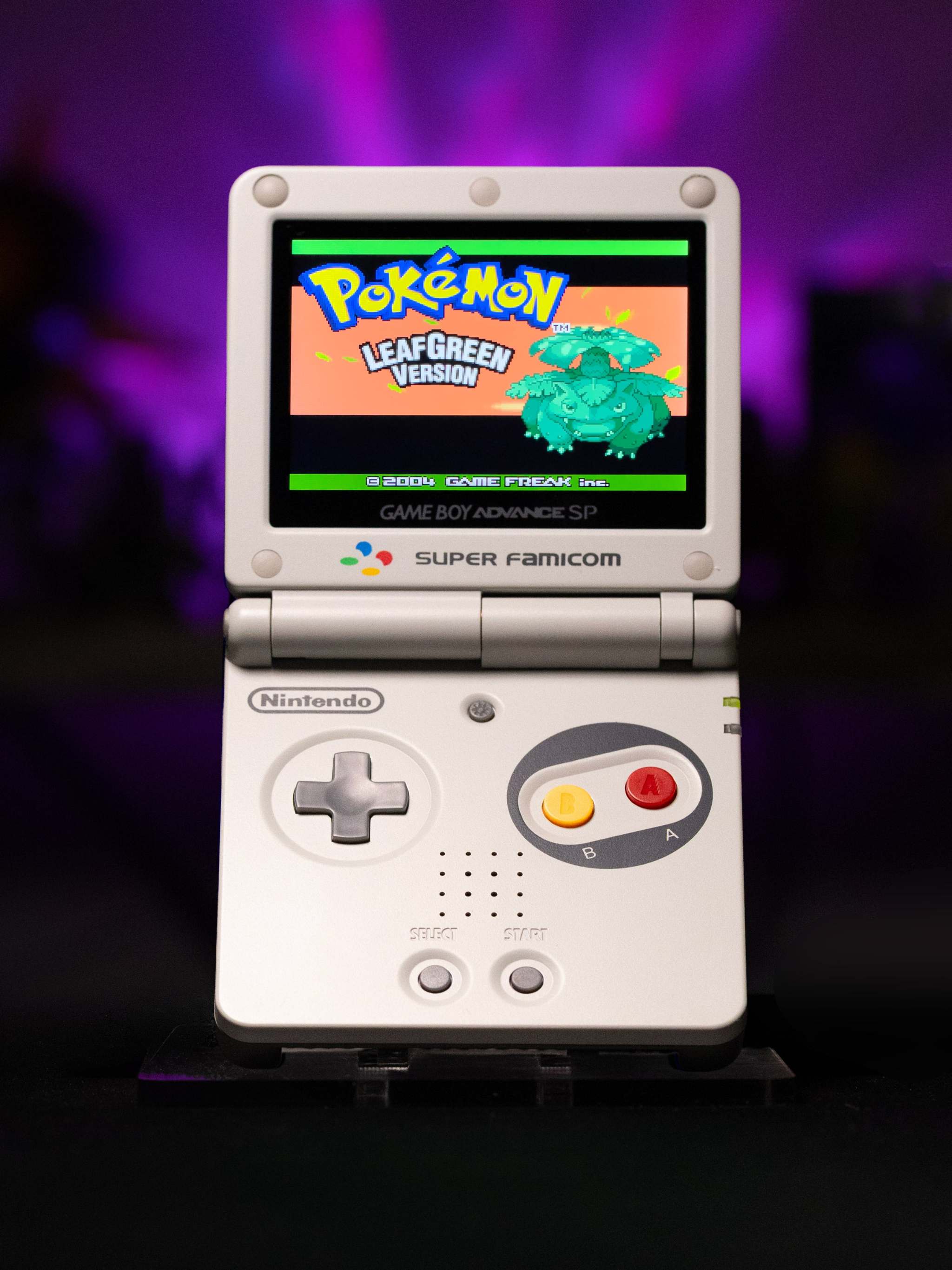 Gameboy Advance SP Super Famicom Edition handheld console with grey shell and colored buttons on IPS V5 backlit display