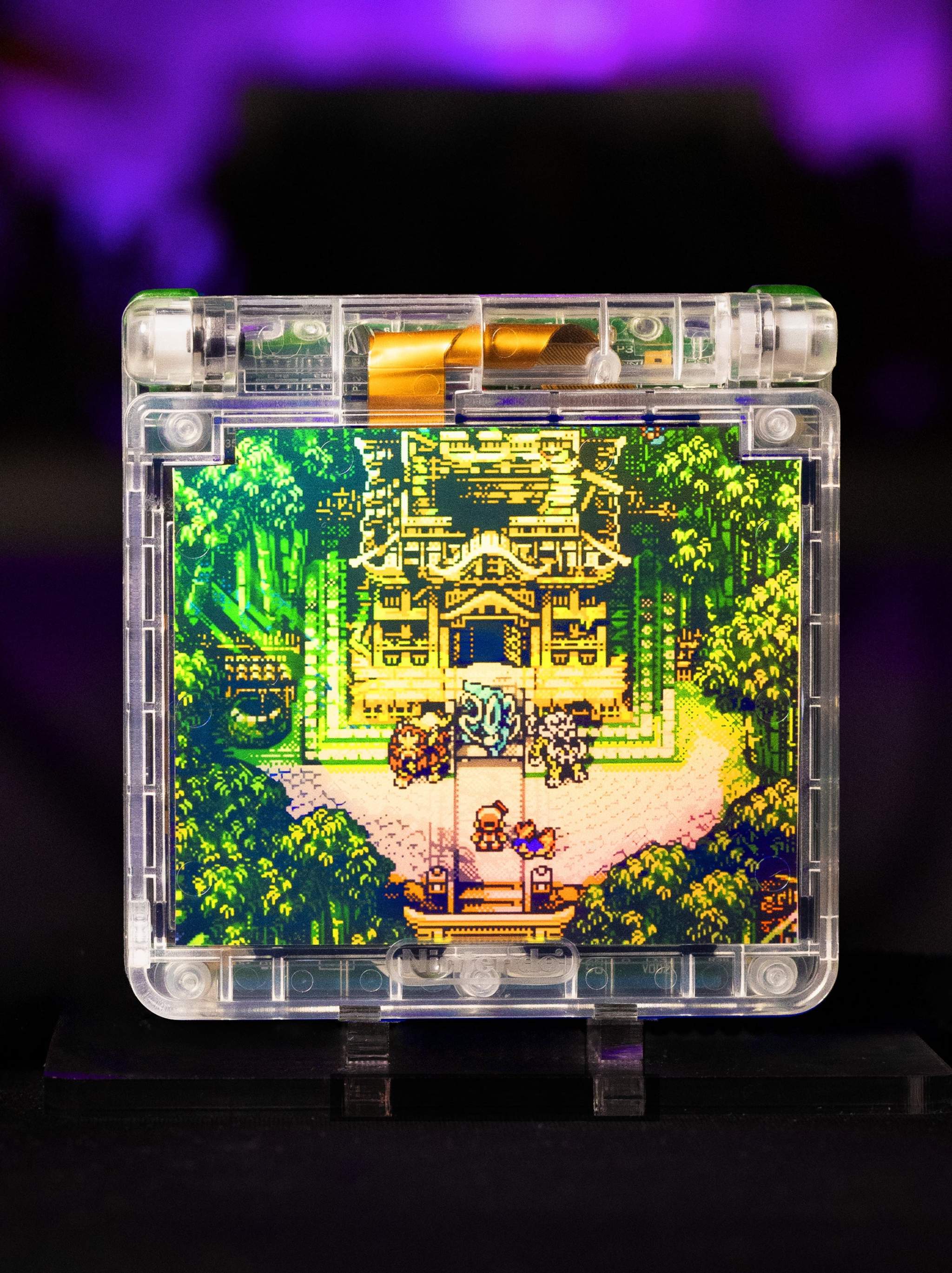 Game Boy Advance SP Legendary Beasts Edition with Johto-inspired artwork and IPS V5 backlit display in transparent shell