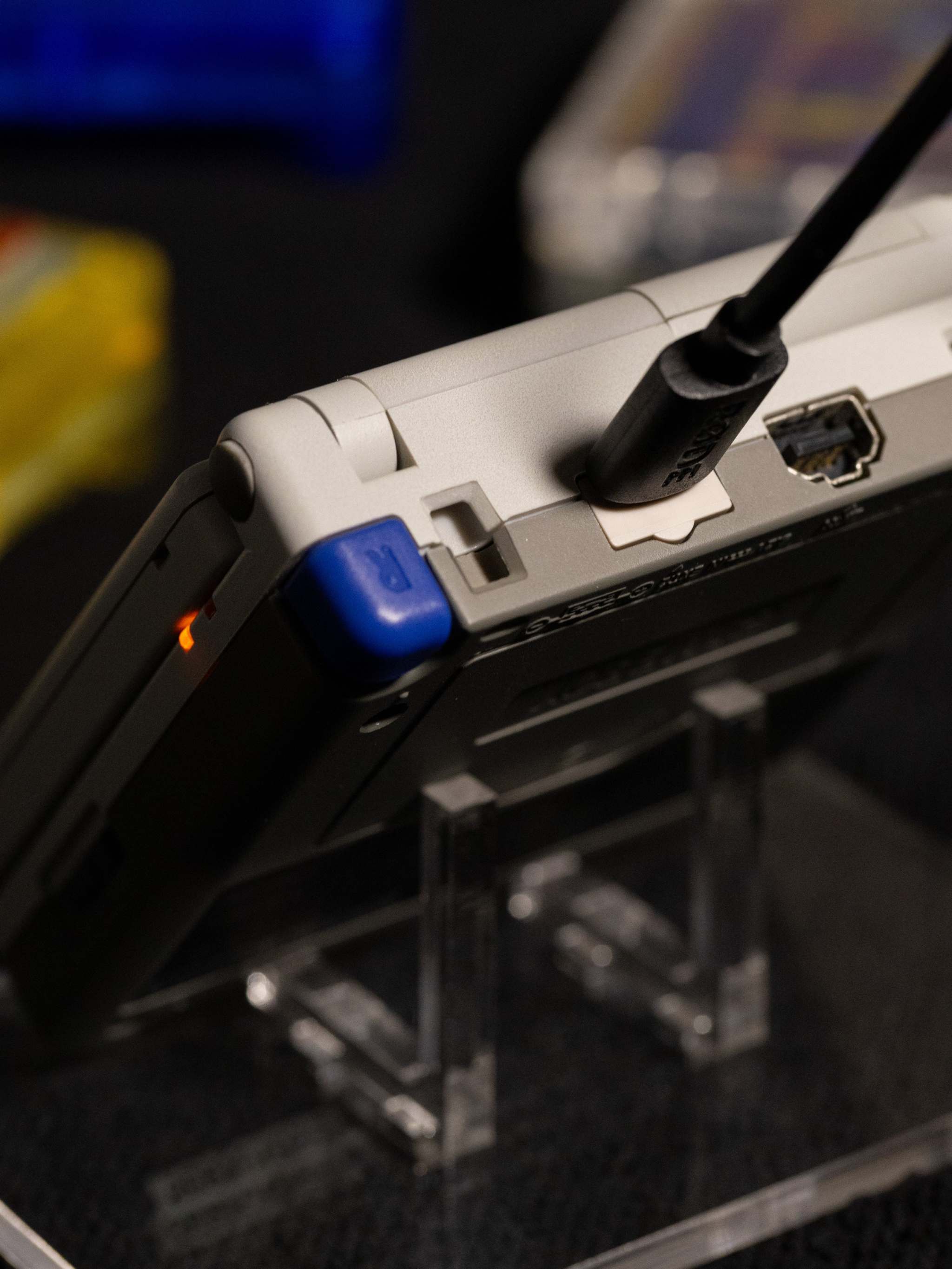 Gameboy Advance SP Super Famicom Edition handheld console with grey shell and colored buttons on a white background